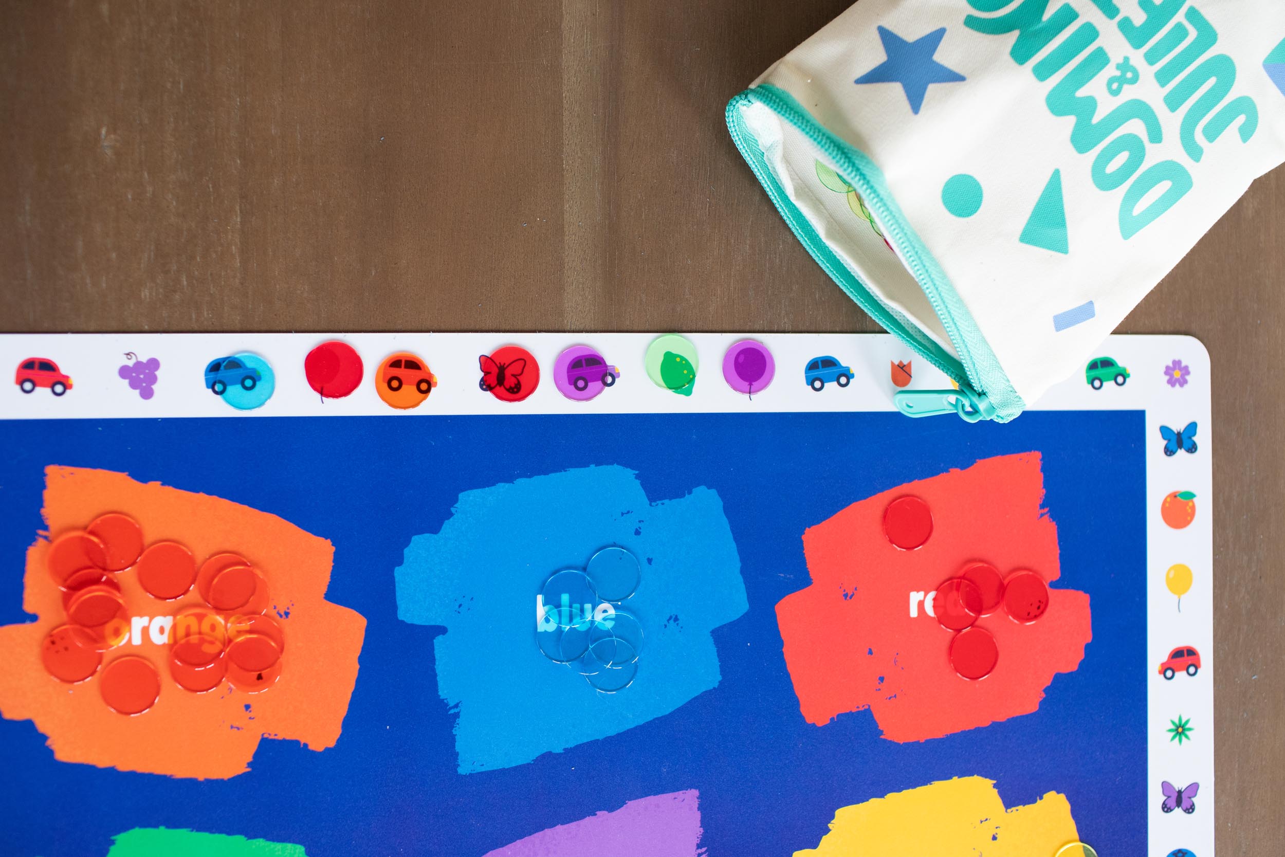 Color placemat, Colors placemat, Colorful placemat, Colorful placemats, Child pointing at color illustrations on placemat, Placemat with Butterflies and racecars, Placemat for kindergartners, preschoolers play with placemats, 2-year-old plays with placemat, Keeping a 19-month-old entertained at home with placemat activities