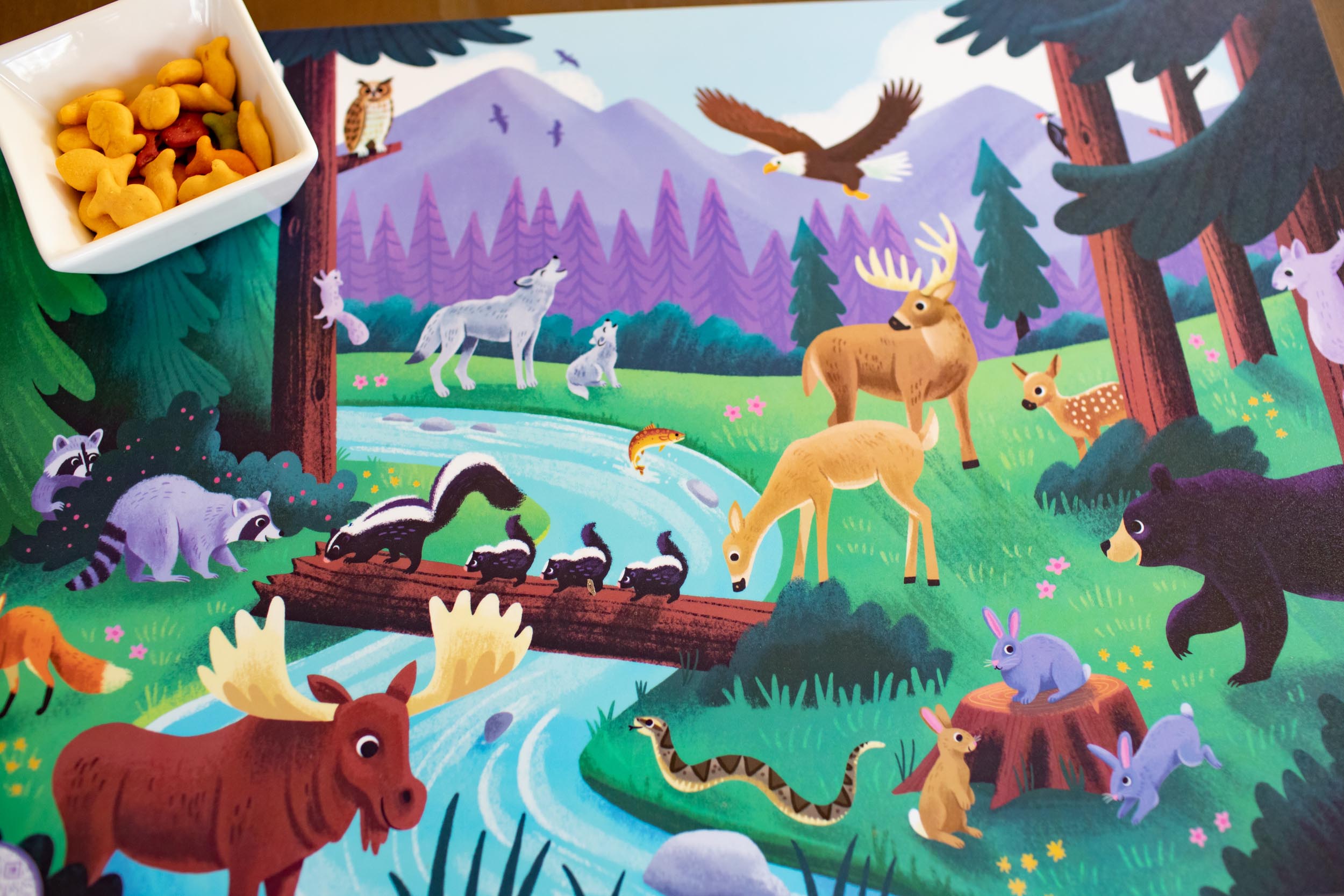 Walk in the Woods Placemat, Furry and feathered forest animal placemat, Walk in the woods placemat with forest animal illustrations, Encourages language development, early math skills, imaginative play, Perfect for indoor activities for 2-year-olds, preschoolers and kindergartners, Provides engaging and educational activities for children, Great ideas for what to play with 2-year-olds and what to do with a 19-month-old at home.